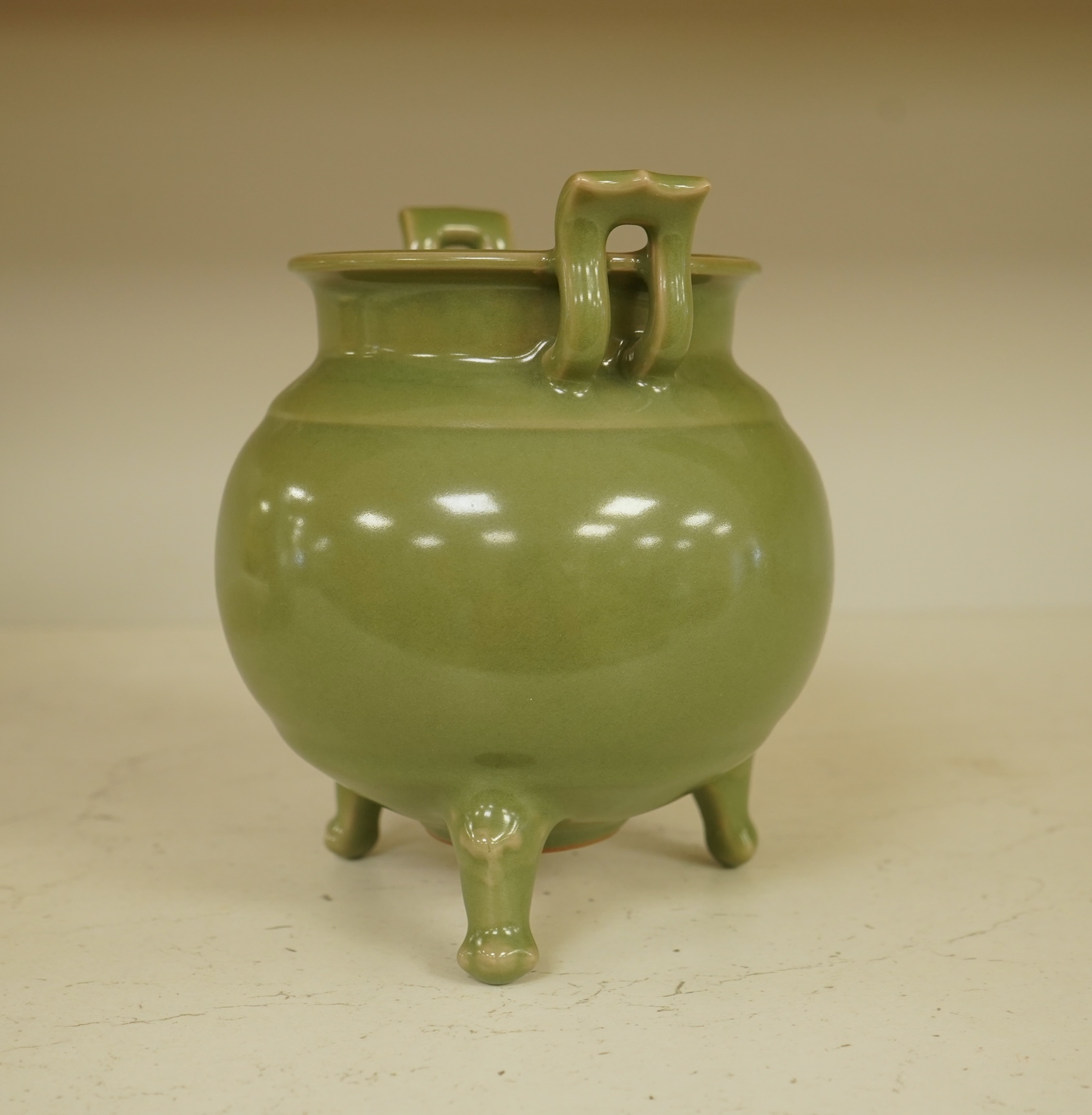 A Chinese green glazed censor on tripod feet, 16cm high